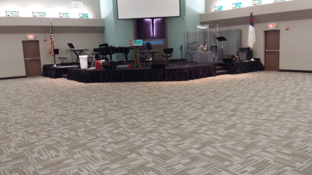 Palm Vist Chruch with a stage setup and carpet flooring